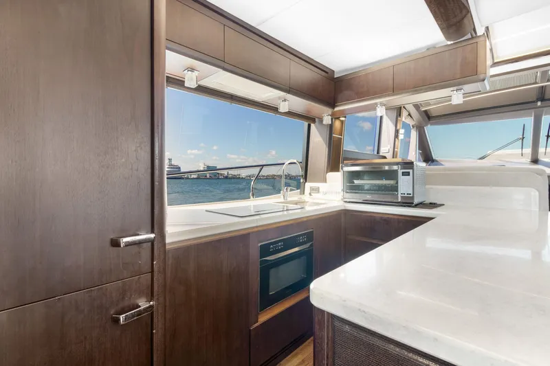 Aquasition Yacht Photos Pics Luxurious kitchen interior of 2020 Galeon 680 Fly yacht with modern appliances and sea view.