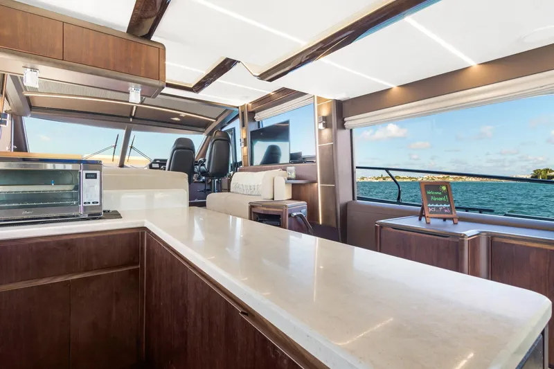 Aquasition Yacht Photos Pics Luxurious interior of 2020 Galeon 680 Fly yacht with modern kitchen and scenic ocean view.