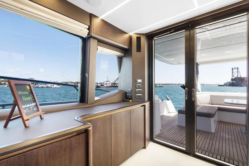 Aquasition Yacht Photos Pics Interior view of 2020 Galeon 680 Fly yacht with ocean backdrop.