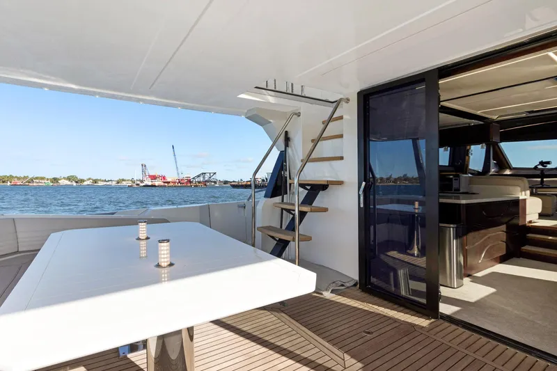 Aquasition Yacht Photos Pics Luxurious 2020 Galeon 680 Fly yacht deck with elegant dining area and scenic ocean view.