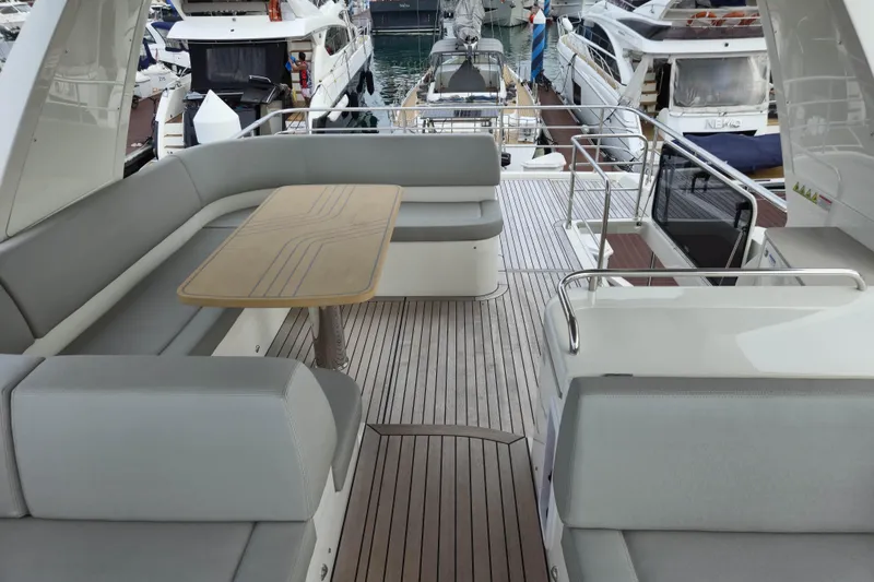  Yacht Photos Pics Luxurious 2025 Absolute Navetta 53 yacht deck with elegant seating and table.