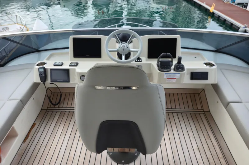  Yacht Photos Pics Helm of 2025 Absolute Navetta 53 yacht with modern controls and wooden deck.
