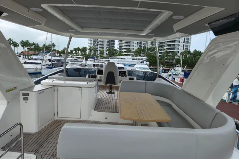  Yacht Photos Pics Luxurious 2025 Absolute Navetta 53 yacht interior with seating and table, docked at marina.