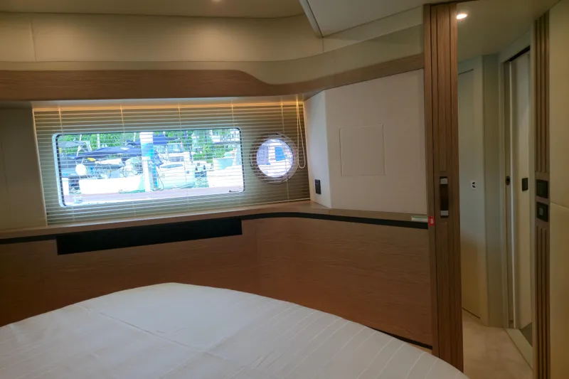  Yacht Photos Pics Luxurious interior of 2025 Absolute Navetta 53 yacht cabin with window view.