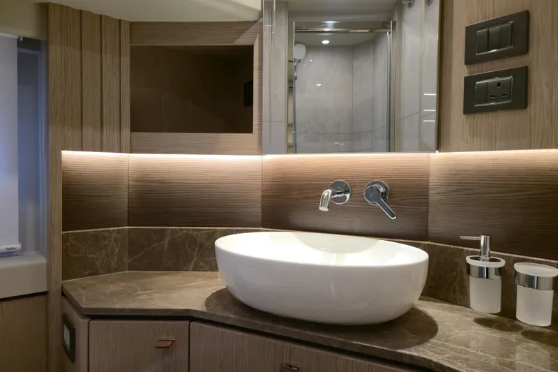  Yacht Photos Pics Luxurious bathroom interior of 2025 Absolute Navetta 53 yacht with modern sink and fixtures.