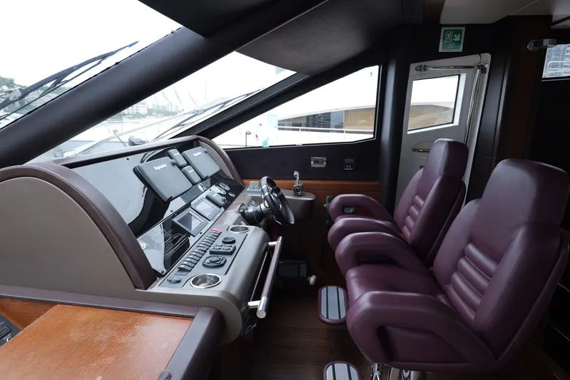  Yacht Photos Pics Interior helm of 2013 Sunseeker Manhattan 73 yacht with leather seats and control panel.