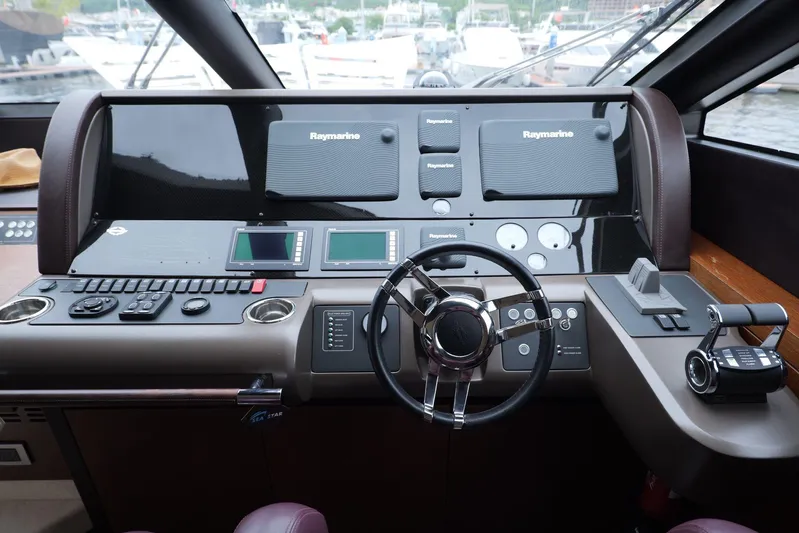  Yacht Photos Pics Cockpit of 2013 Sunseeker Manhattan 73 yacht with advanced navigation controls and steering wheel.