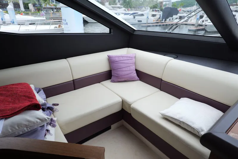  Yacht Photos Pics Luxurious interior seating on a 2013 Sunseeker Manhattan 73 yacht with cushions and pillows.