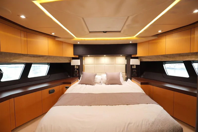  Yacht Photos Pics Luxurious Sunseeker Manhattan 73 yacht bedroom interior, 2013 model, featuring elegant wood finishes.