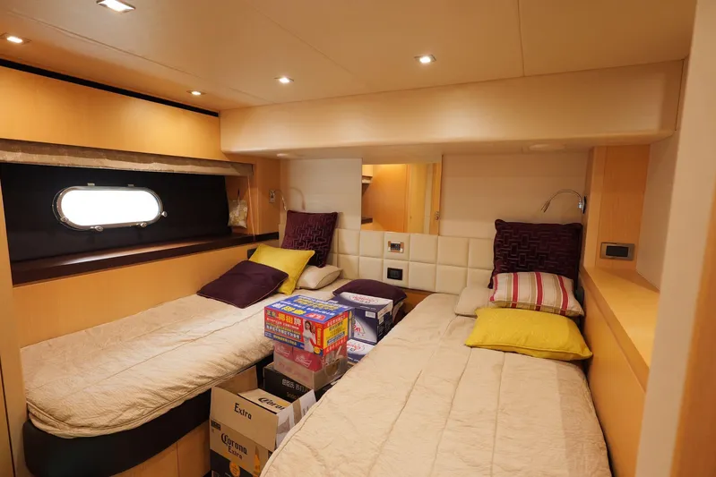  Yacht Photos Pics Luxurious Sunseeker Manhattan 73 cabin interior with twin beds, cozy lighting, and modern decor.