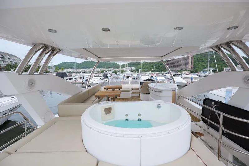  Yacht Photos Pics Luxurious Sunseeker Manhattan 73 yacht with jacuzzi and seating area, docked at marina.