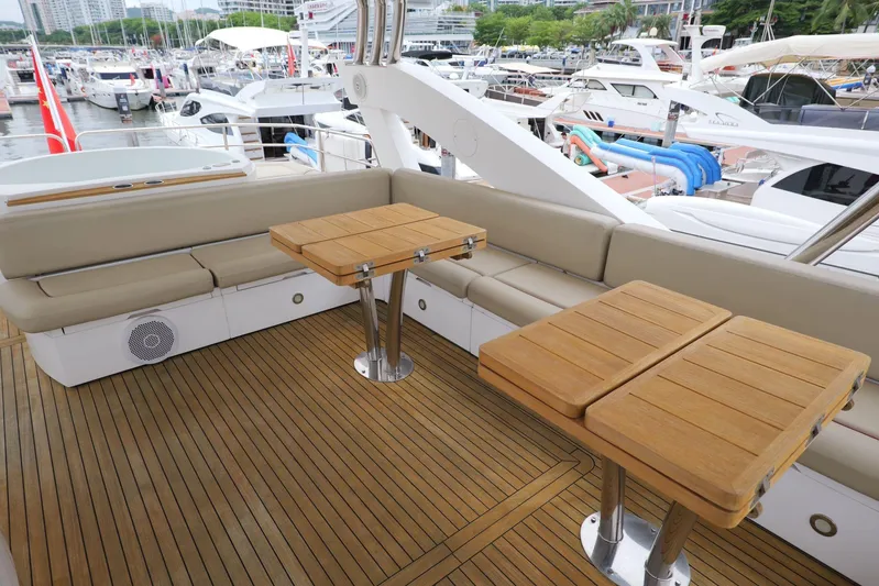  Yacht Photos Pics Luxurious Sunseeker Manhattan 73 yacht deck with wooden tables and seating, 2013 model.