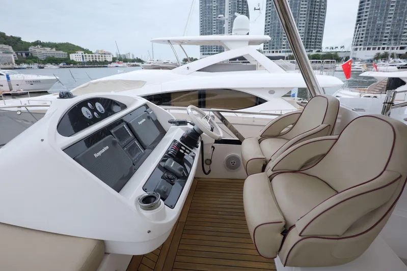  Yacht Photos Pics Luxurious 2013 Sunseeker Manhattan 73 yacht helm with modern controls and plush seating.