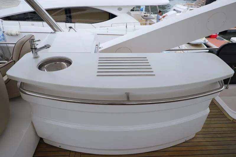  Yacht Photos Pics Luxury yacht Sunseeker Manhattan 73, 2013 model, featuring a sleek outdoor bar area.