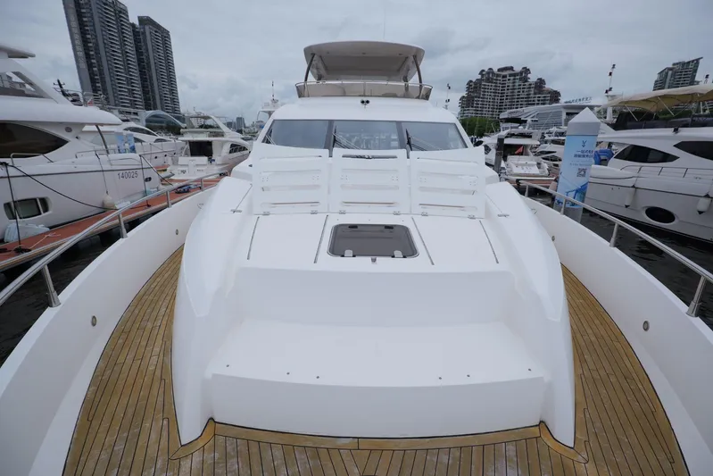  Yacht Photos Pics Luxurious 2013 Sunseeker Manhattan 73 yacht docked at marina, showcasing sleek design.