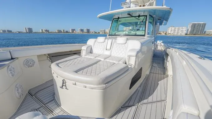 Reel Addiction Yacht Photos Pics Luxury 2016 HCB Suenos 53 yacht with spacious deck and seating, cruising near city skyline.