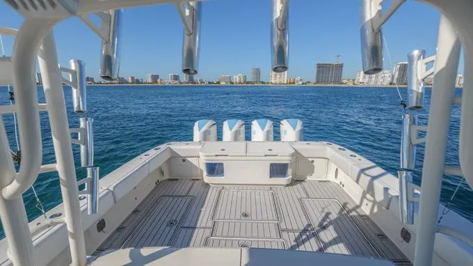 Reel Addiction Yacht Photos Pics HCB Suenos 53 boat deck, 2016 model, overlooking calm blue waters and city skyline.