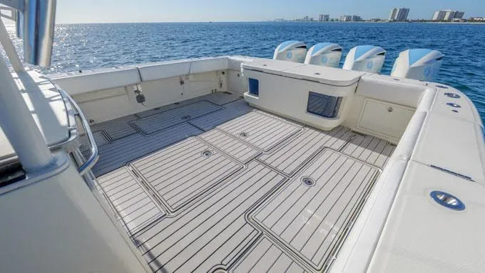 Reel Addiction Yacht Photos Pics HCB Suenos 53 boat deck, 2016 model, with ocean view and city skyline in background.