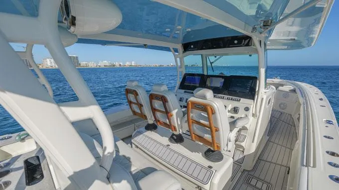 Reel Addiction Yacht Photos Pics Interior view of 2016 HCB Suenos 53 boat, featuring helm and seating, on open water.