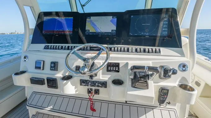 Reel Addiction Yacht Photos Pics Helm of 2016 HCB Suenos 53 with advanced navigation displays and controls.