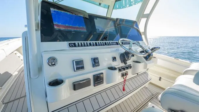 Reel Addiction Yacht Photos Pics Helm of 2016 HCB Suenos 53 boat with advanced navigation systems, steering wheel, and ocean view.