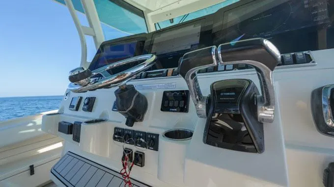 Reel Addiction Yacht Photos Pics Helm of 2016 HCB Suenos 53 boat with steering wheel and controls.