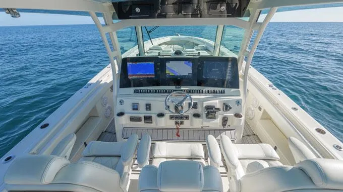 Reel Addiction Yacht Photos Pics Helm of 2016 HCB Suenos 53 boat with advanced navigation systems on open sea.