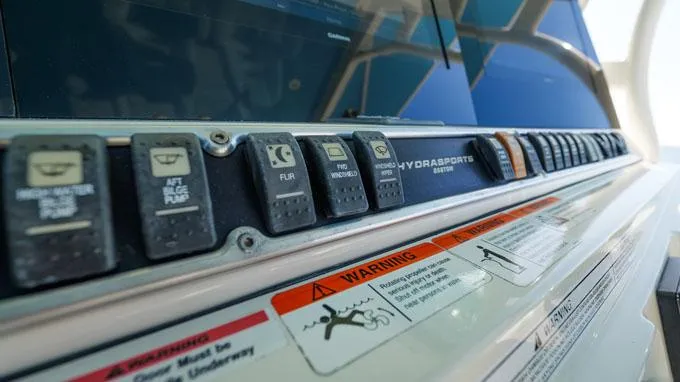 Reel Addiction Yacht Photos Pics Control panel of a 2016 HCB Suenos 53 boat with warning labels.