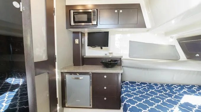 Reel Addiction Yacht Photos Pics Interior of 2016 HCB Suenos 53 yacht with kitchenette and seating area.