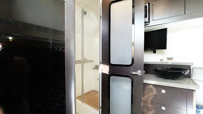 Reel Addiction Yacht Photos Pics Interior of 2016 HCB Suenos 53 yacht featuring modern bathroom and sleek cabinetry.