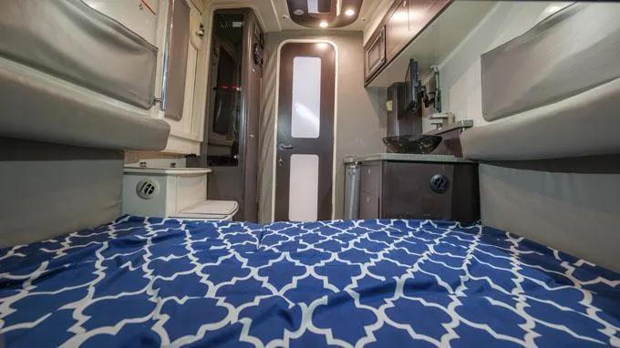 Reel Addiction Yacht Photos Pics Interior cabin of 2016 HCB Suenos 53 boat with blue patterned bedding.