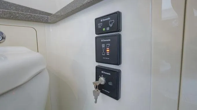 Reel Addiction Yacht Photos Pics Control panel inside 2016 HCB Suenos 53 boat, featuring Dometic switches and key access.