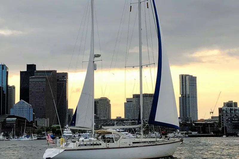 Iteration Yacht Photos Pics Sailboat Amel 53 Super Maramu 1994 in urban harbor at sunset.