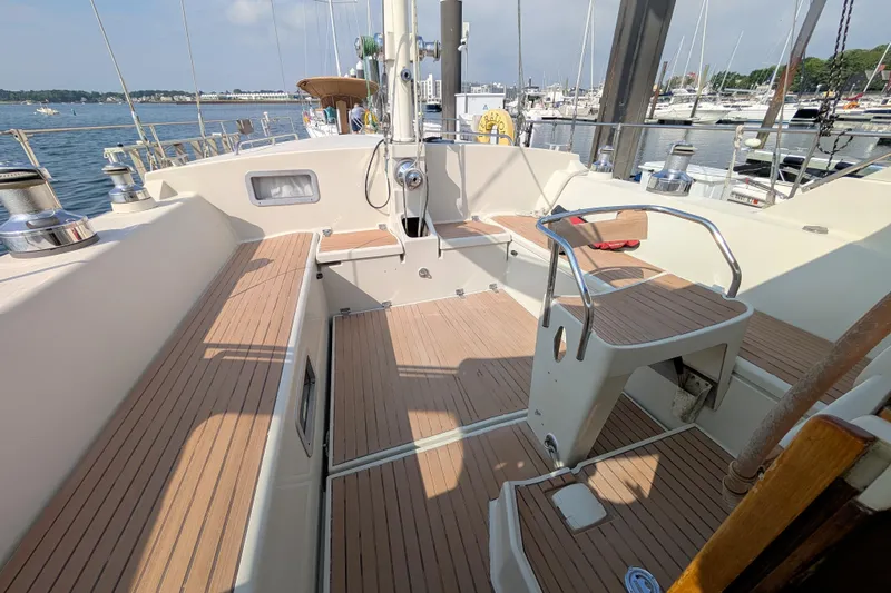 Iteration Yacht Photos Pics Cockpit of 1994 Amel 53 Super Maramu sailboat with teak decking and marina view.