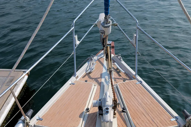 Iteration Yacht Photos Pics Bow of 1994 Amel 53 Super Maramu sailboat with teak deck and stainless steel fittings.