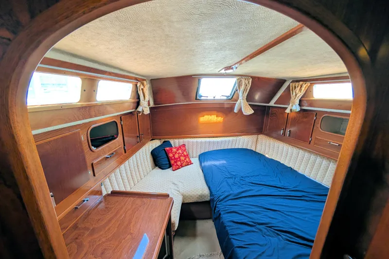 Iteration Yacht Photos Pics Cozy cabin interior of 1994 Amel 53 Super Maramu sailboat with wood finish and bed.