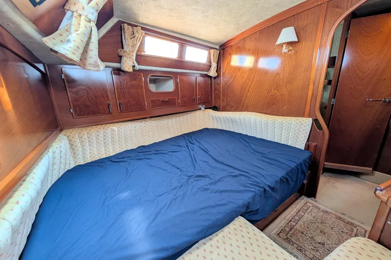Iteration Yacht Photos Pics Cozy cabin interior of 1994 Amel 53 Super Maramu sailboat with wood paneling.