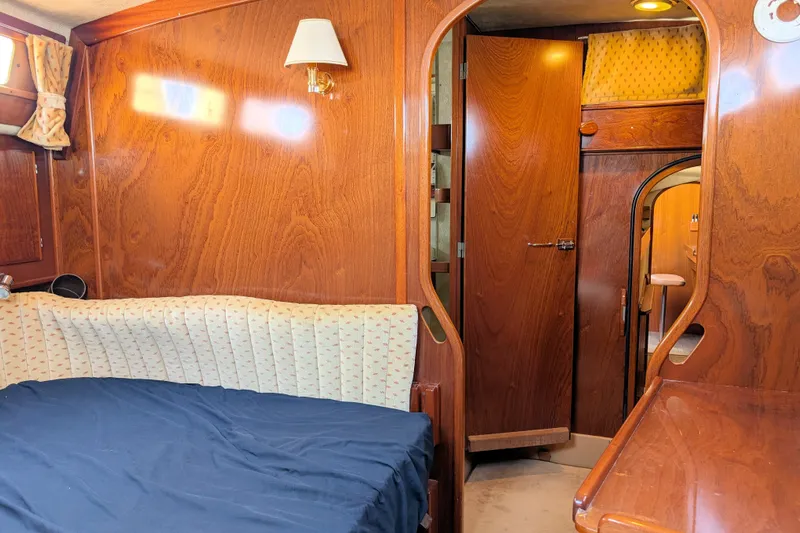 Iteration Yacht Photos Pics Interior of 1994 Amel 53 Super Maramu sailboat with wood paneling and cozy cabin.