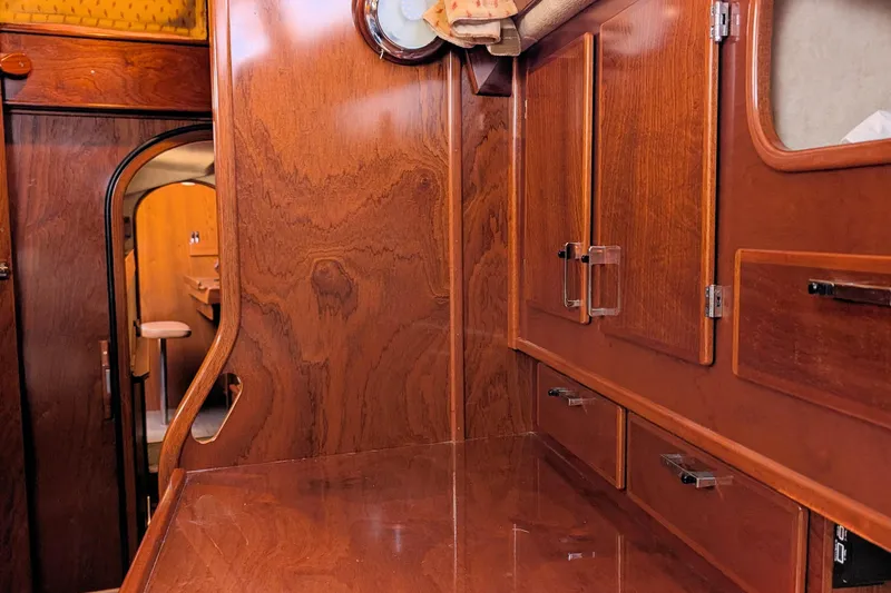 Iteration Yacht Photos Pics Interior of 1994 Amel 53 Super Maramu yacht with polished wooden cabinetry.