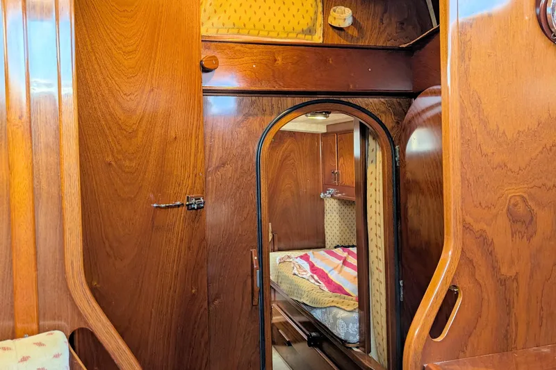 Iteration Yacht Photos Pics Interior of 1994 Amel 53 Super Maramu sailboat with wooden finish and cozy cabin.