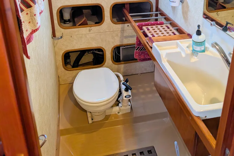 Iteration Yacht Photos Pics Bathroom of 1994 Amel 53 Super Maramu yacht with toilet and sink.