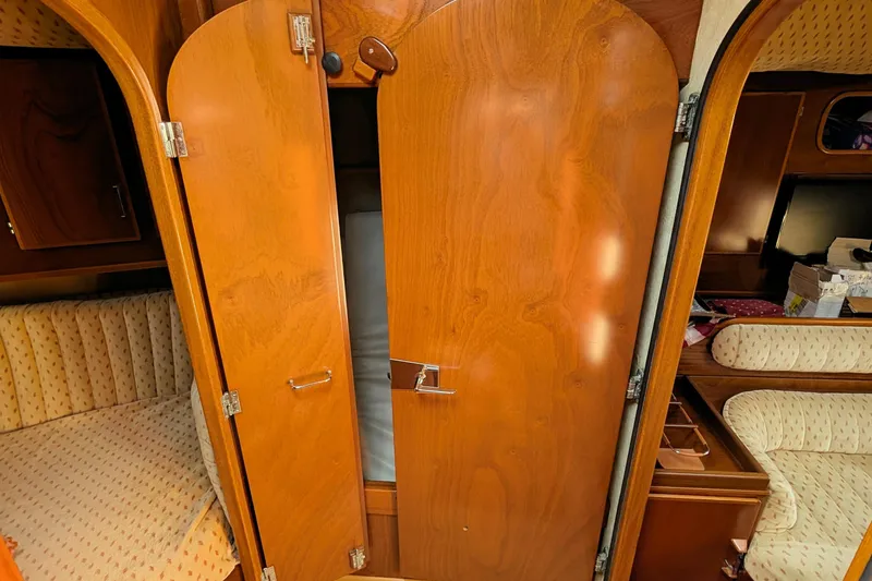 Iteration Yacht Photos Pics Interior of 1994 Amel 53 Super Maramu sailboat with wooden cabinetry and cozy seating.