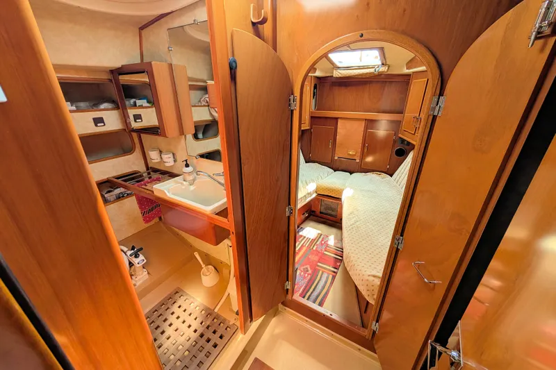 Iteration Yacht Photos Pics Interior of 1994 Amel 53 Super Maramu yacht, featuring cozy cabin and wooden finishes.