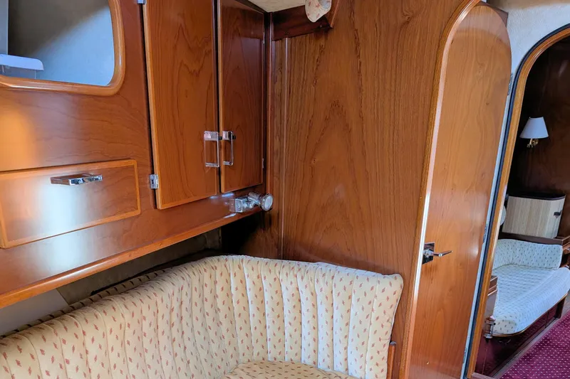 Iteration Yacht Photos Pics Interior of 1994 Amel 53 Super Maramu yacht with wooden cabinetry and upholstered seating.