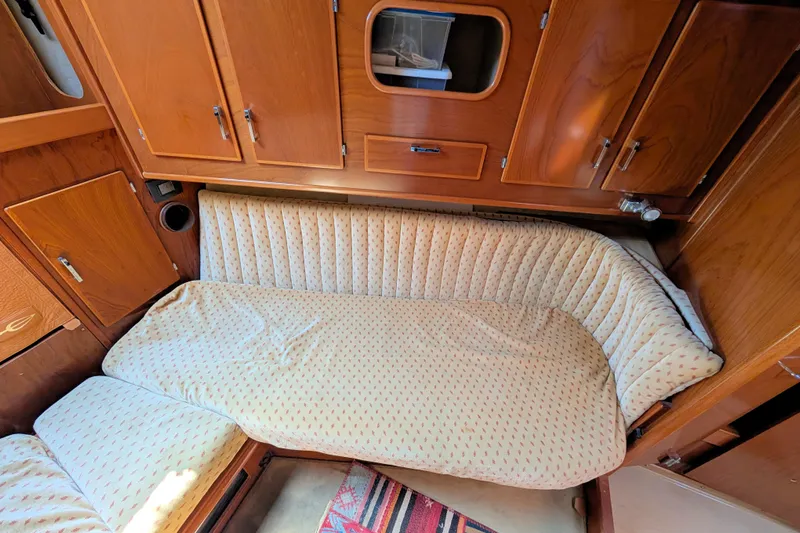 Iteration Yacht Photos Pics Cozy cabin interior of 1994 Amel 53 Super Maramu sailboat with wooden cabinetry.