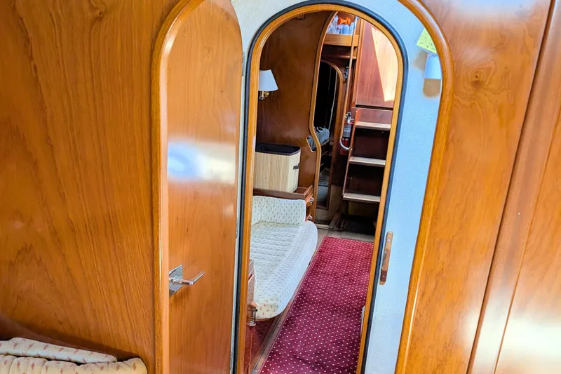 Iteration Yacht Photos Pics Interior of 1994 Amel 53 Super Maramu yacht with wooden finish and cozy seating.