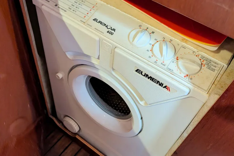 Iteration Yacht Photos Pics Washing machine inside 1994 Amel 53 Super Maramu yacht, featuring Eumenia Euronova 600 model.