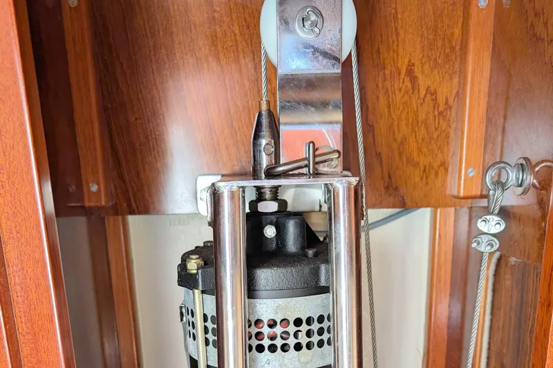 Iteration Yacht Photos Pics Close-up of 1994 Amel 53 Super Maramu sailboat winch mechanism with wooden paneling.