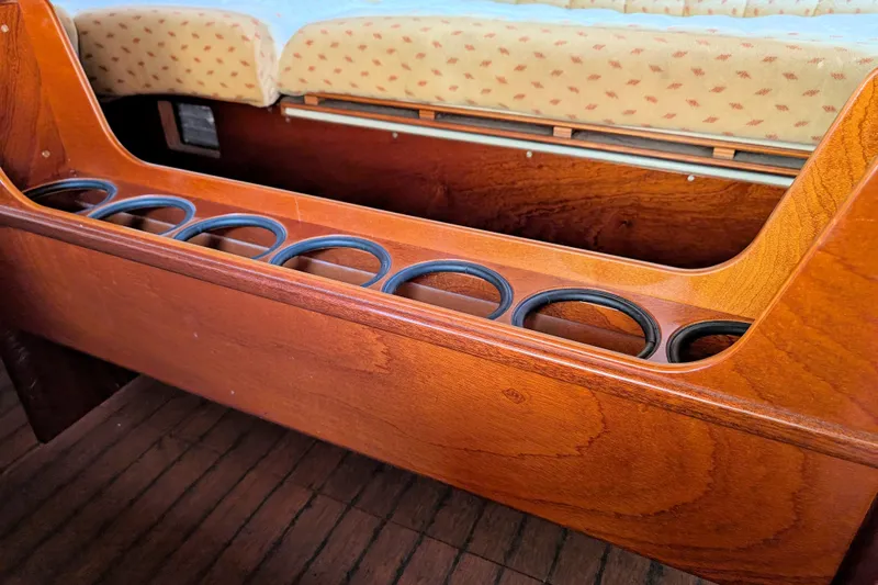 Iteration Yacht Photos Pics Interior of 1994 Amel 53 Super Maramu yacht with wooden cup holders and cushioned seating.