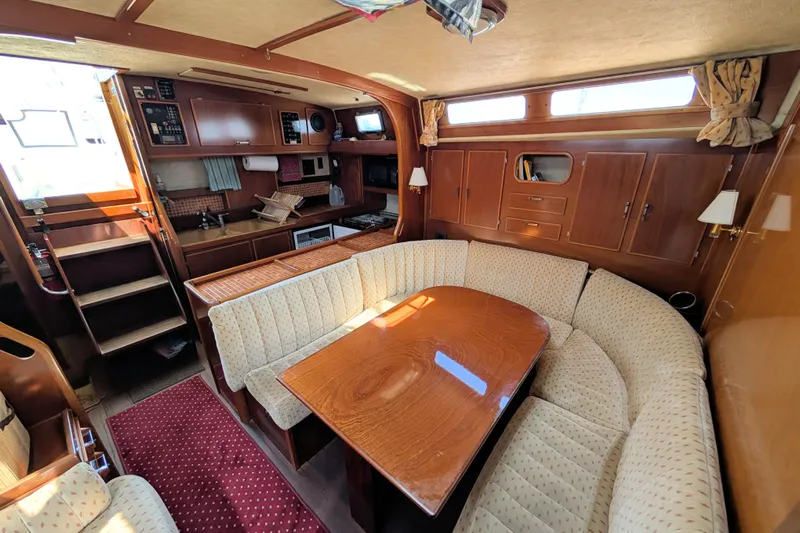 Iteration Yacht Photos Pics Interior of 1994 Amel 53 Super Maramu yacht with cozy seating and wooden finishes.